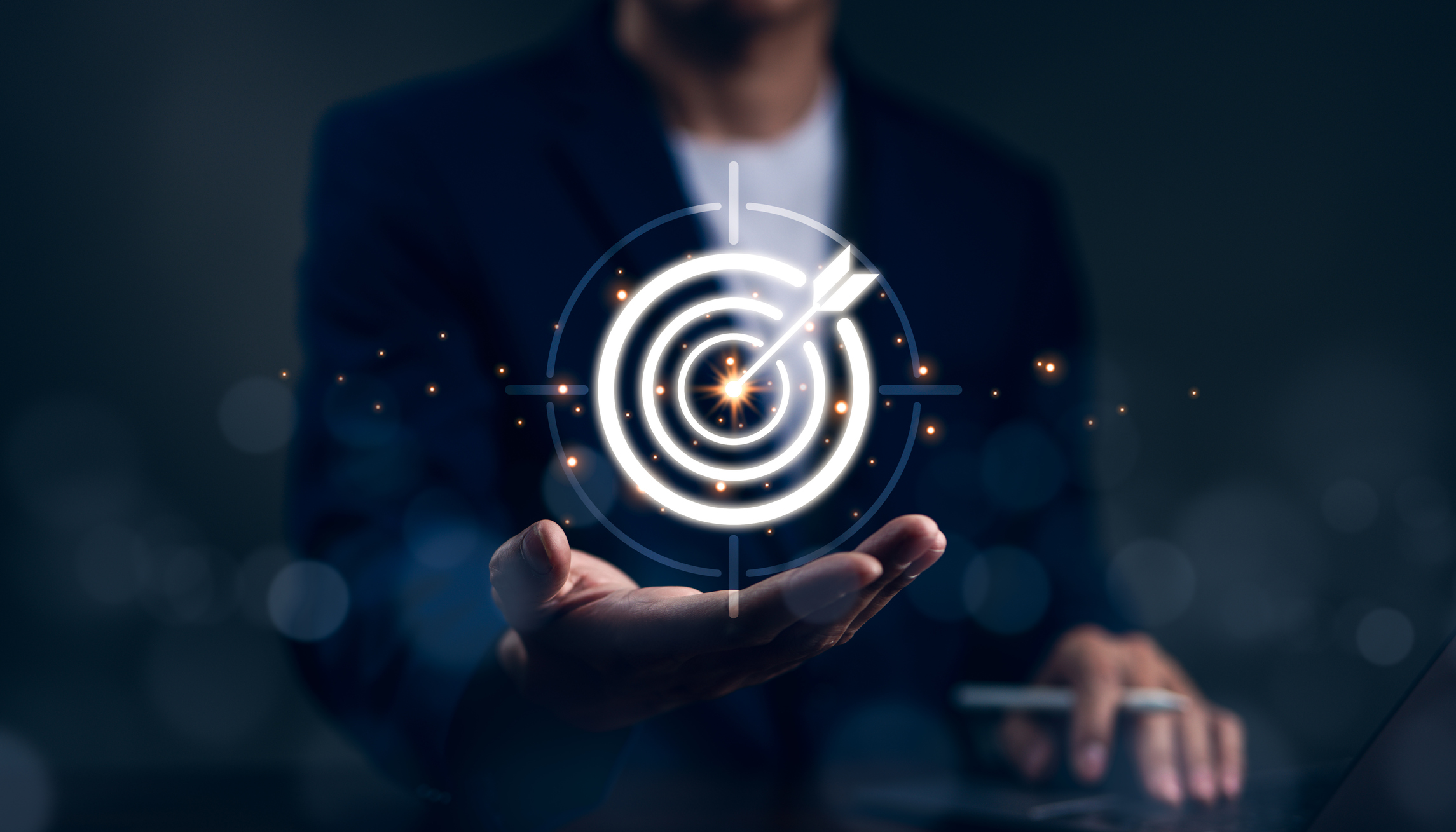 A sales rep holds a virtual image of a target, representing prospecting with aesthetic market insights