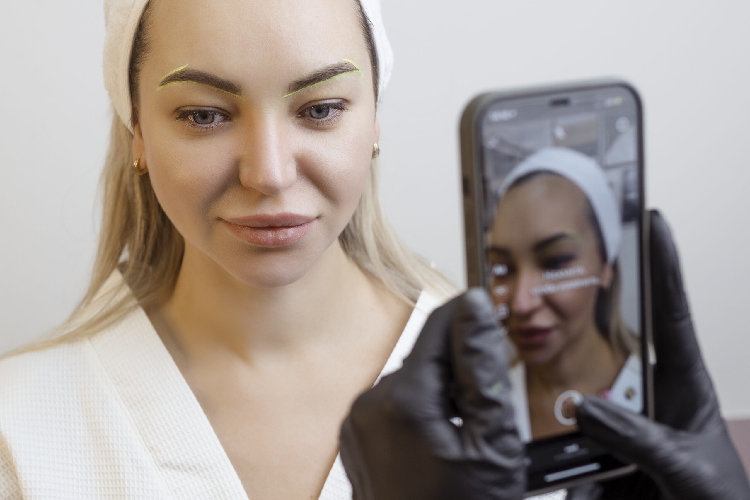 A practitioner influencer takes a photo of a medical aesthetics patient to post on social media channels