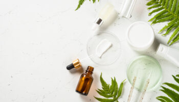 Top view of professional grade skincare vials and neurotoxin syringes, representing cross-purchasing patient purchasing behavior in medical aesthetics