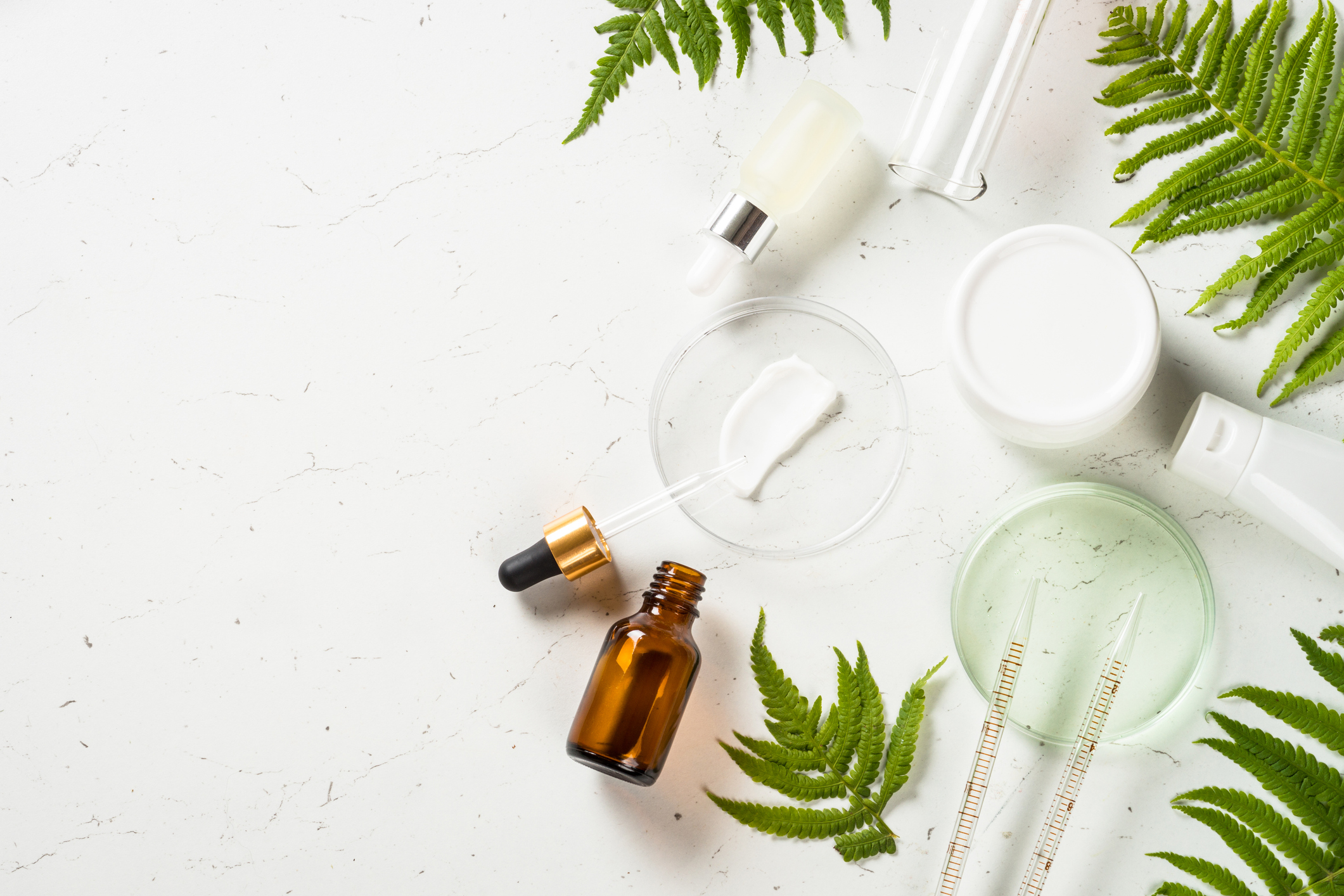 Top view of professional grade skincare vials and neurotoxin syringes, representing cross-purchasing patient purchasing behavior in medical aesthetics